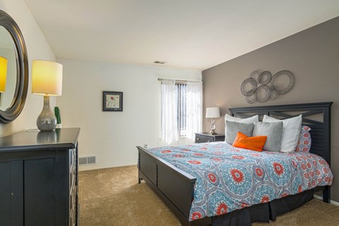 Comfortable bedroom with natural light at Park Lane Apartments in Southfield, MI